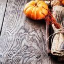 thanksgiving utensils with pumpkin on wooden table