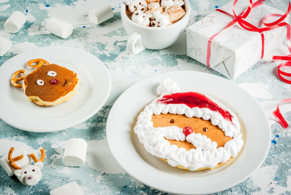 santa and reindeer pancakes sitting on plates