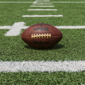 Wilson football on a turf field at the 50 yard line