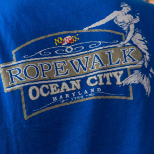 Back of a blue t-shirt with the Ropewalk Ocean City logo