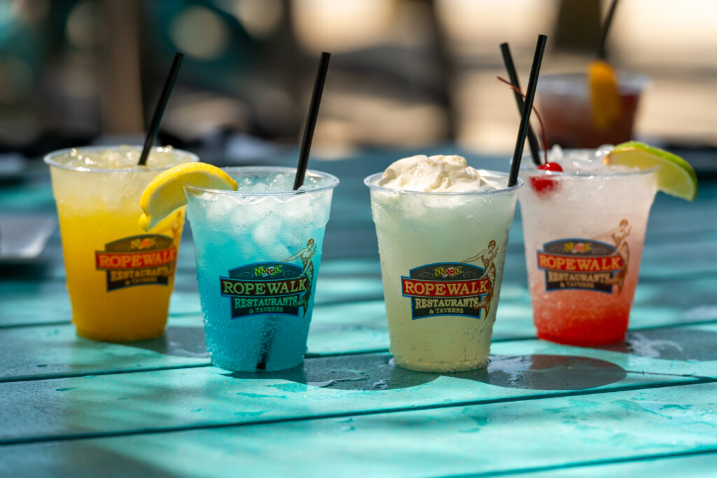 4 alcoholic beverages on a blue table.