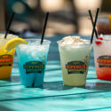 4 alcoholic beverages on a blue table.