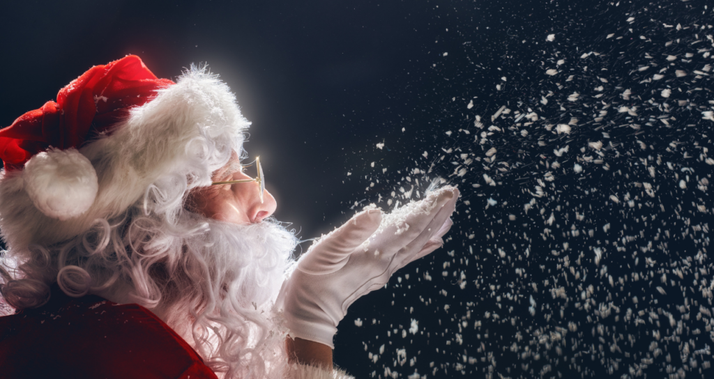 santa blowing snow from his hands