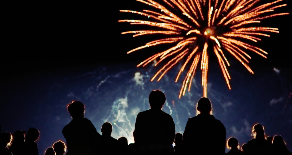 A crowd of people watching fireworks