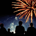 A crowd of people watching fireworks